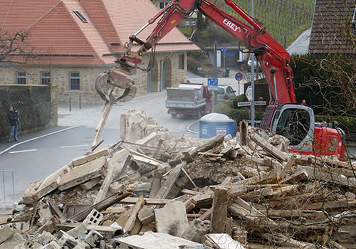 Tractor Demolishing A House